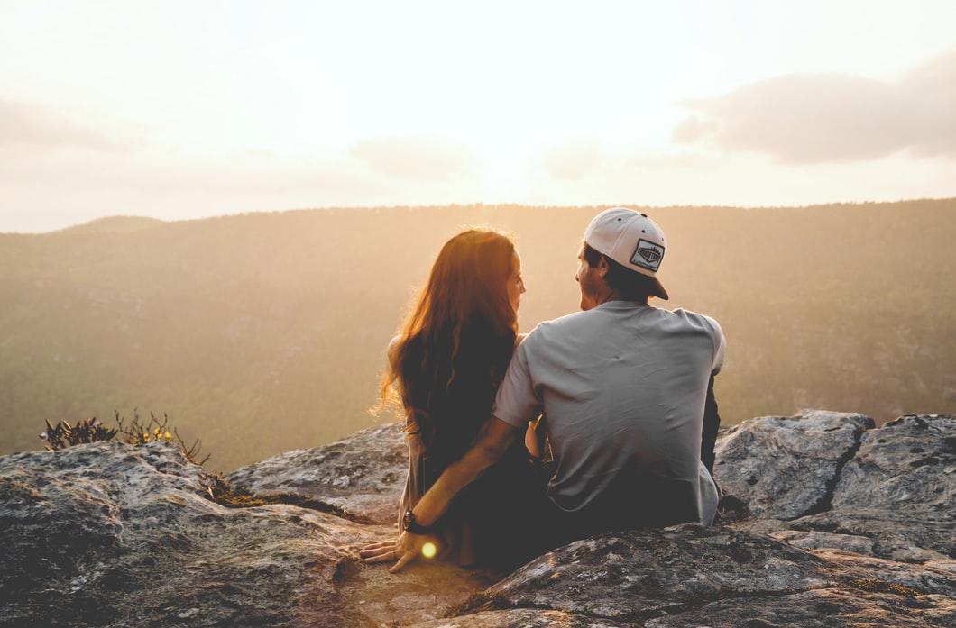 couple sitting in front of a view