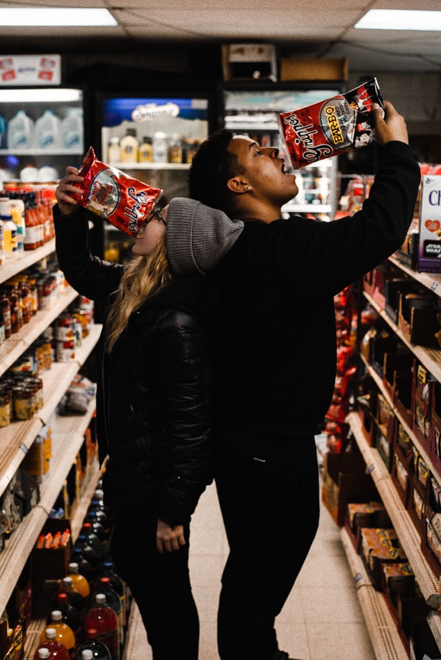 Couple eating chips in a store